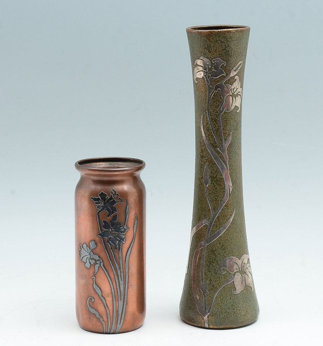 2 PC. HEINTZ & SILVERCREST ARTS & CRAFTS VASES: 2 PC. HEINTZ & SILVERCREST ARTS & CRAFTS VASES: Comprising; 1- Tall Silvercrest bronze vase, having Sterling overlay Daffodils. Underside bares impressed Silvercrest mark & #8091. 1- Heintz bronze cyl
