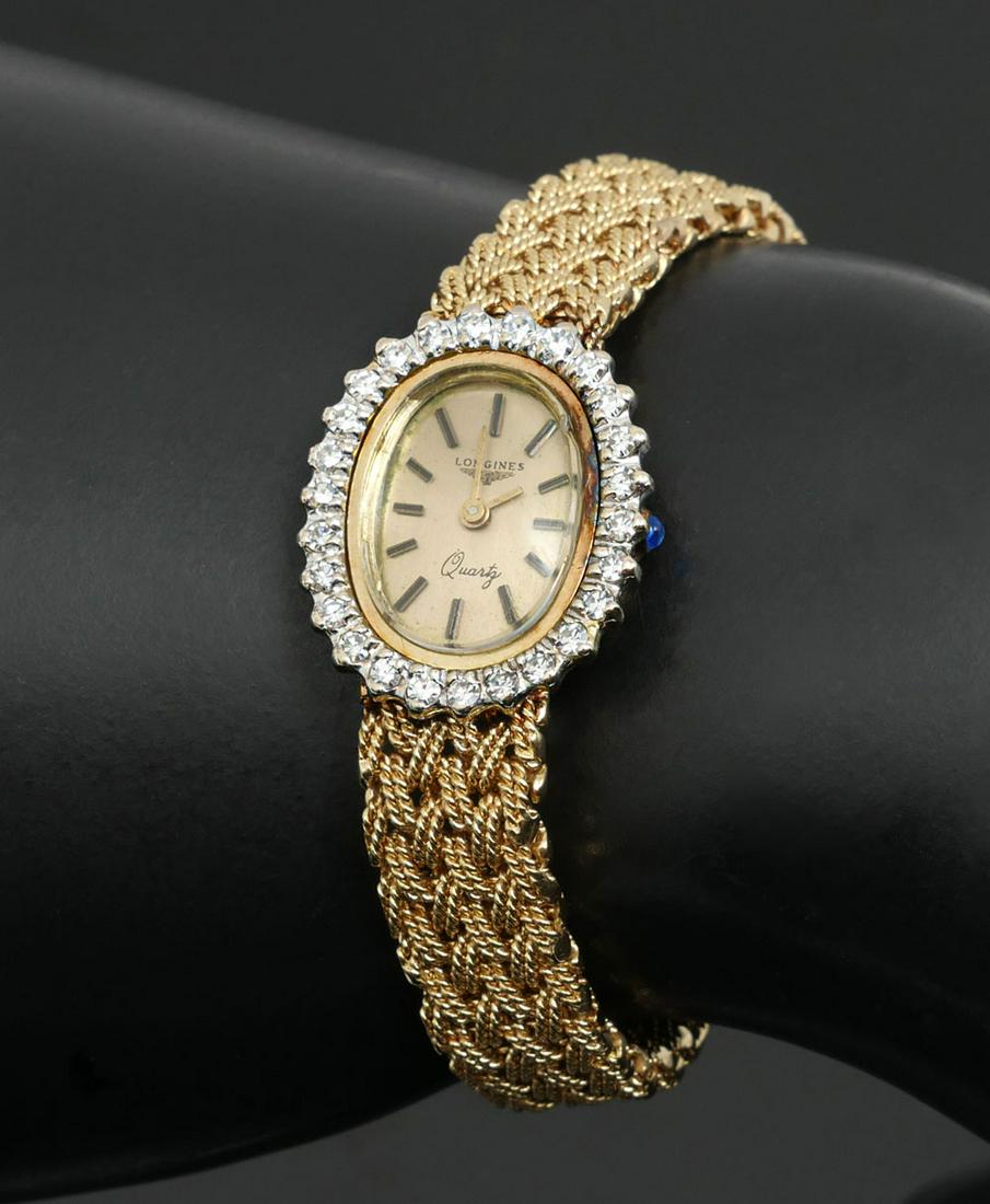 14K LONGINES QUARTZ WATCH WITH DIAMOND BEZEL: 14K LONGINES QUARTZ WATCH WITH DIAMOND BEZEL: 14K yellow gold ladies Longines watch with diamond bezel. The dial is gold color marked ''Longines'' and Quartz with bar markers for the numbers. It has a