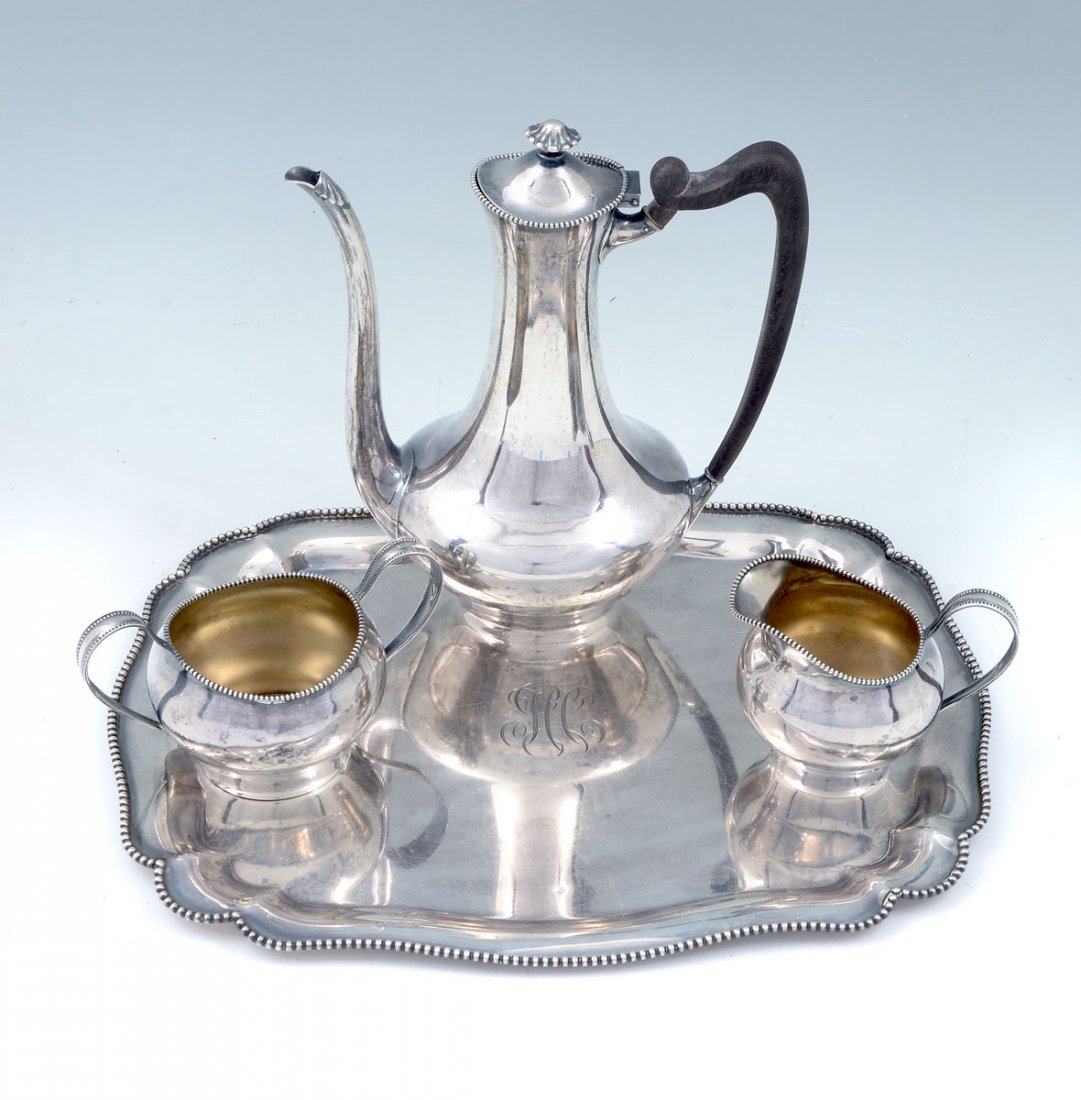 4 PC. STERLING TOWLE TEA SET: 4 PC. STERLING TOWLE TEA SET: Approx. 33.26 Troy ounces. Comprising; 1- Serving platter, 1- Teapot, 1- Sugar bowl, & 1- Creamer. All monogrammed, and bare impressed Towle marks at undersides. Teapot A