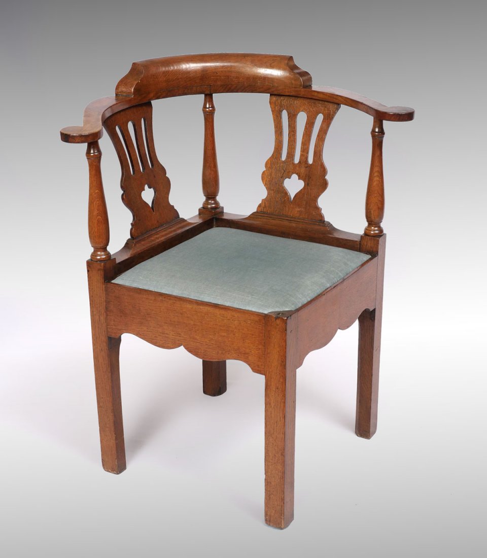 18TH CENTURY OAK CORNER CHAIR: 18TH CENTURY OAK CORNER CHAIR: Circa 1760 Oak corner chair upholstered in a greyish fabric, shaped crotch. Approx. 33" h x 28.5" l x 24.5" w. Provenance: Fred S. and Rosemary Johnston Estate.
