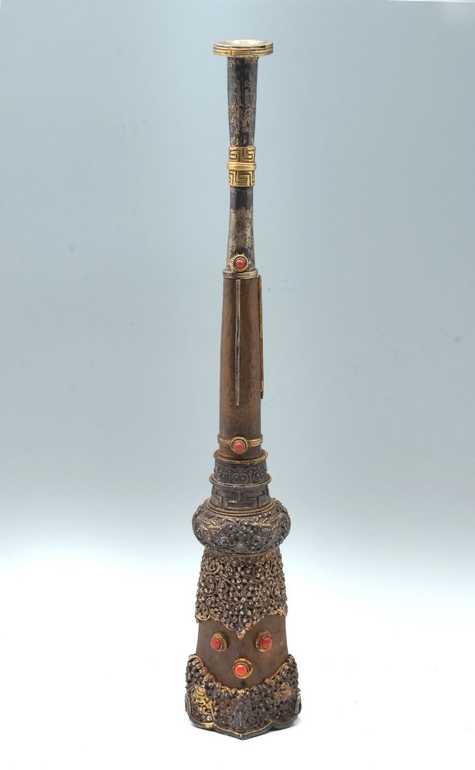 CHINESE TIBETAN BUDDHIST CEREMONIAL HORN: CHINESE TIBETAN BUDDHIST CEREMONIAL HORN: Hand-hammered copper bodied Tibetan ceremonial horn, having a Chinese Silver openwork scrolling cloud design with Dragons & Buddhist symbols. Adorned by inset