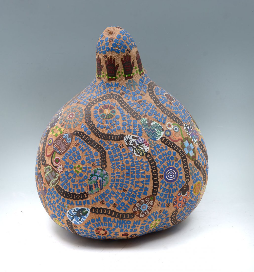 MICHELLE "TEJUOOLA" TURNER FOLK ART GOURD: MICHELLE "TEJUOOLA" TURNER FOLK ART GOURD: Carved and Painted Gourd with Yoruba African theme, 18" h. With "American Vsions" magazine and article on the artist.