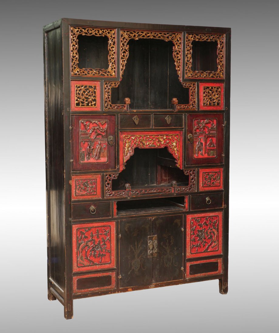 CHINESE CARVED BUDDHIST SHRINE: CHINESE CARVED BUDDHIST SHRINE: Large 4- door, 4- drawer Chinese shrine cabinet, having elaborately carved & pierced scrolling foliate borders. Carved figural scenes at two doors. Approx. 65.25" h x 4