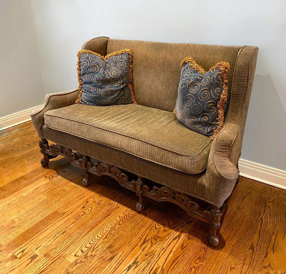 CARVED SETTEE: CARVED SETTEE: Settee upholstered in a ribbed brown fabric. Carved scrolling foliate frame, raised on scrolled feet. Approx. 40.5'' h x 68'' l x 32'' w.