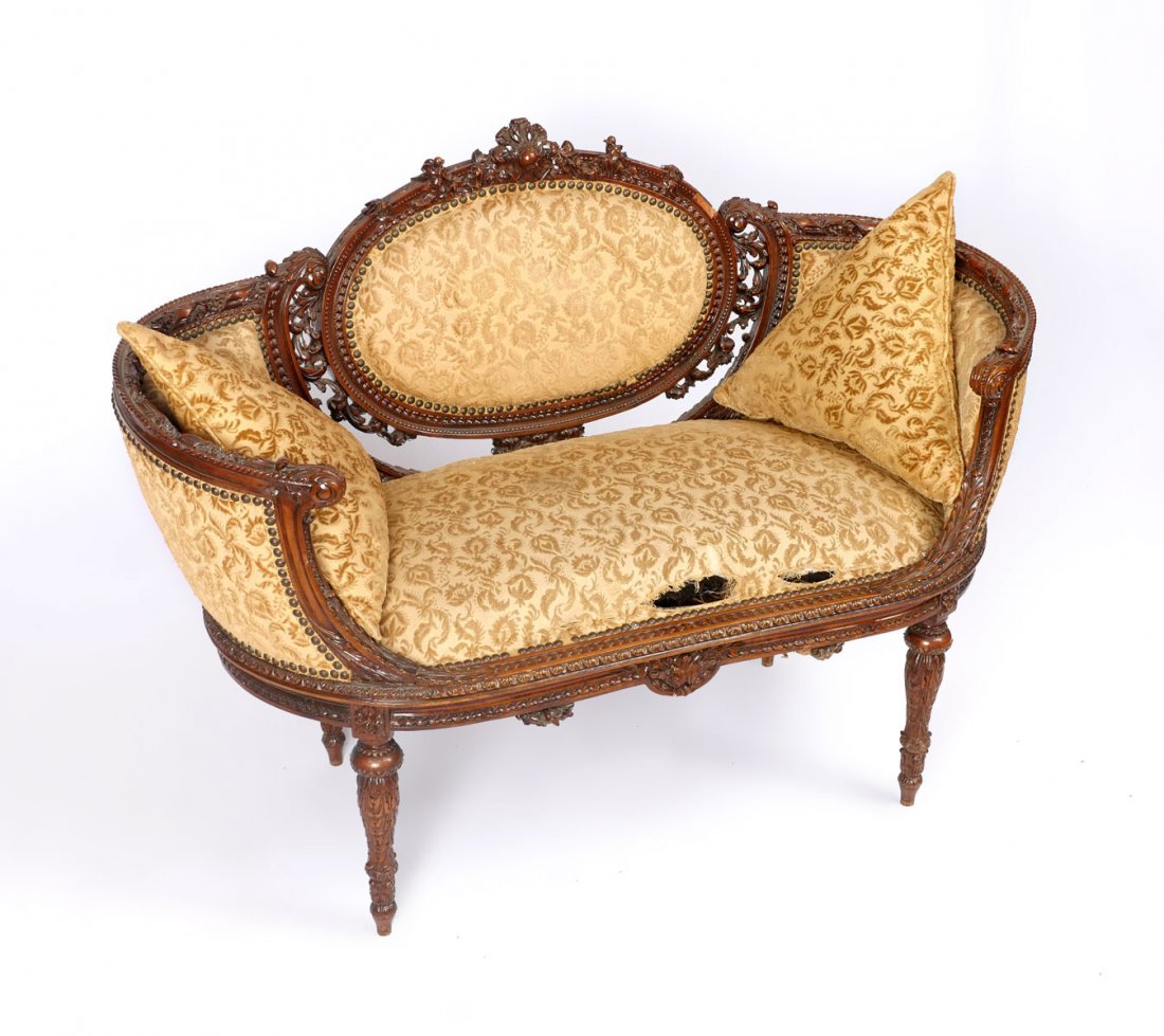 HEAVILY CARVED DIMINUTIVE SETTEE: HEAVILY CARVED DIMINUTIVE SETTEE: Extensively carved diminutive settee having an overall foliate, Acanthus, & ribbon design with birds at pierced backrest. Upholstered in a raised foliate pattern. Rai