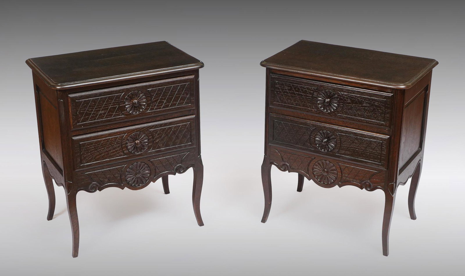 PAIR OF QUEEN MARY STYLE DRAWER NIGHTSTANDS: PAIR OF QUEEN MARY STYLE DRAWER NIGHTSTANDS: 2- Carved Queen Anne style 2- drawer nightstands, having central carved medallions at drawers and at shaped crotch. Medallions flanked by carved geometrica