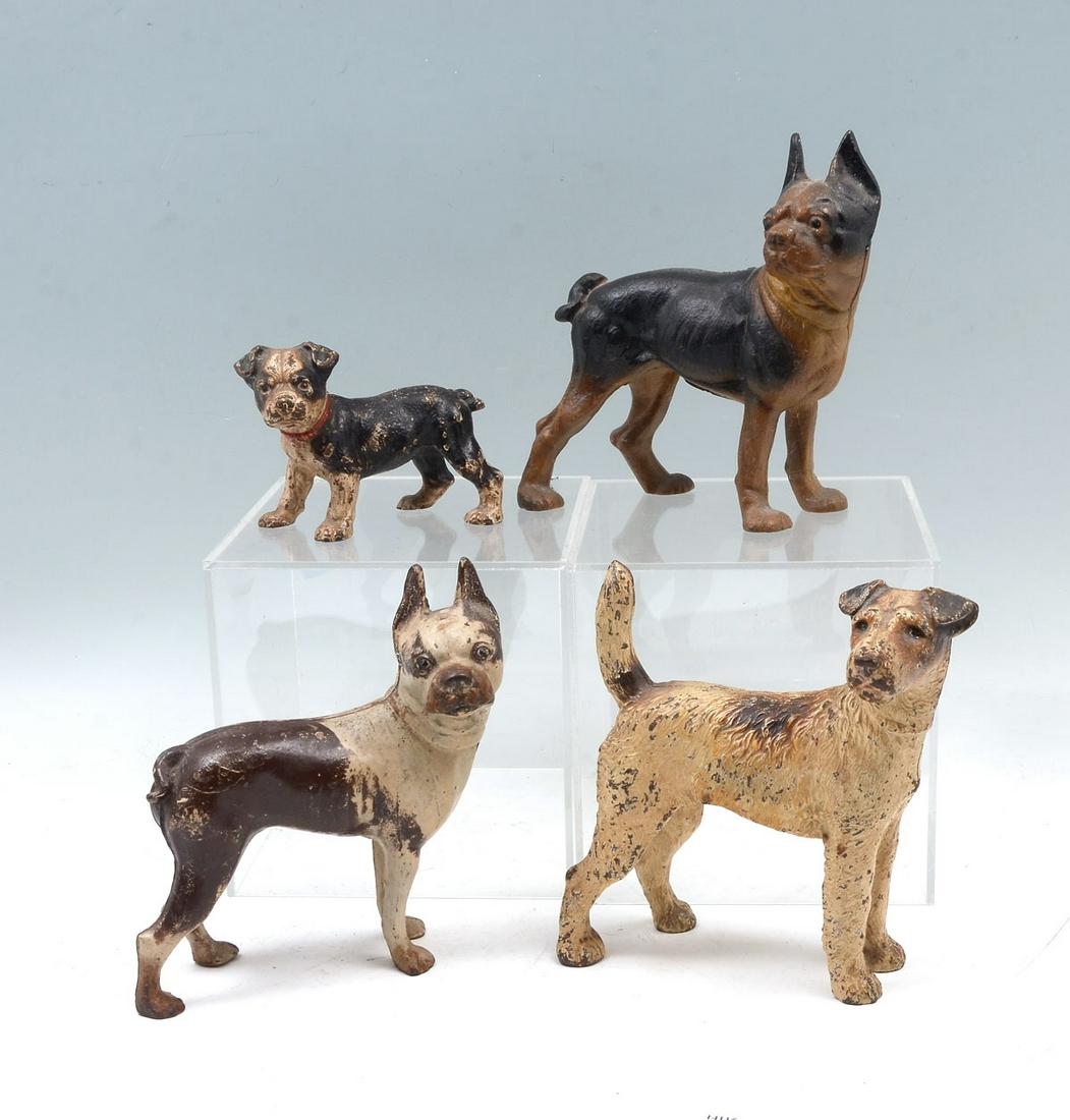 4 CAST IRON DOG DOORSTOPS: 4 CAST IRON DOG DOORSTOPS: Comprising; 1- Solid cast iron dog & 3- seamed cast iron dogs. Largest Approx. 8.5'' h x 8.75'' l x 4.5'' w.