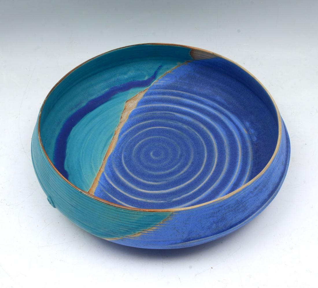 CONTEMPORARY ARTIST SIGNED POTTERY BOWL: CONTEMPORARY ARTIST SIGNED POTTERY BOWL: Large hand-thrown artist signed pottery bowl, having cobalt blue & aqua glazes. Raised artist mark at side. Approx. 4.25'' h x 16.25'' w.