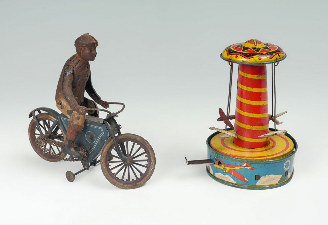2 TIN WIND UP TOYS: 2 TIN WIND UP TOYS: Comprising; 1- Four Airplane Whirly Gig & 1- Chain driven wind-up Motorcycle. Largest Approx. 7" h x 7.5" l x 4" w.