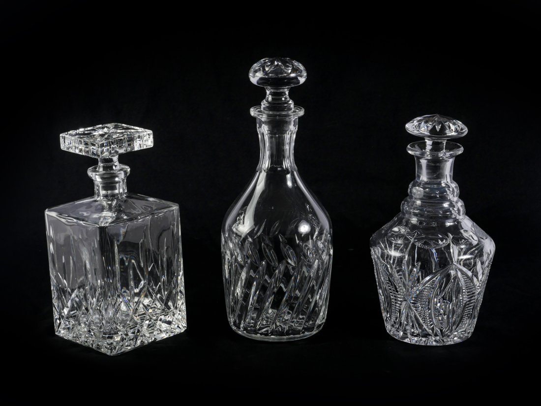 3 LEAD CRYSTAL AND CUT GLASS DECANTERS: 3 LEAD CRYSTAL AND CUT GLASS DECANTERS: Comprising; 1- Square crystal decanter, 2- round cut glass decanters. Largest Approx. 11.25" h x 4.5" w.