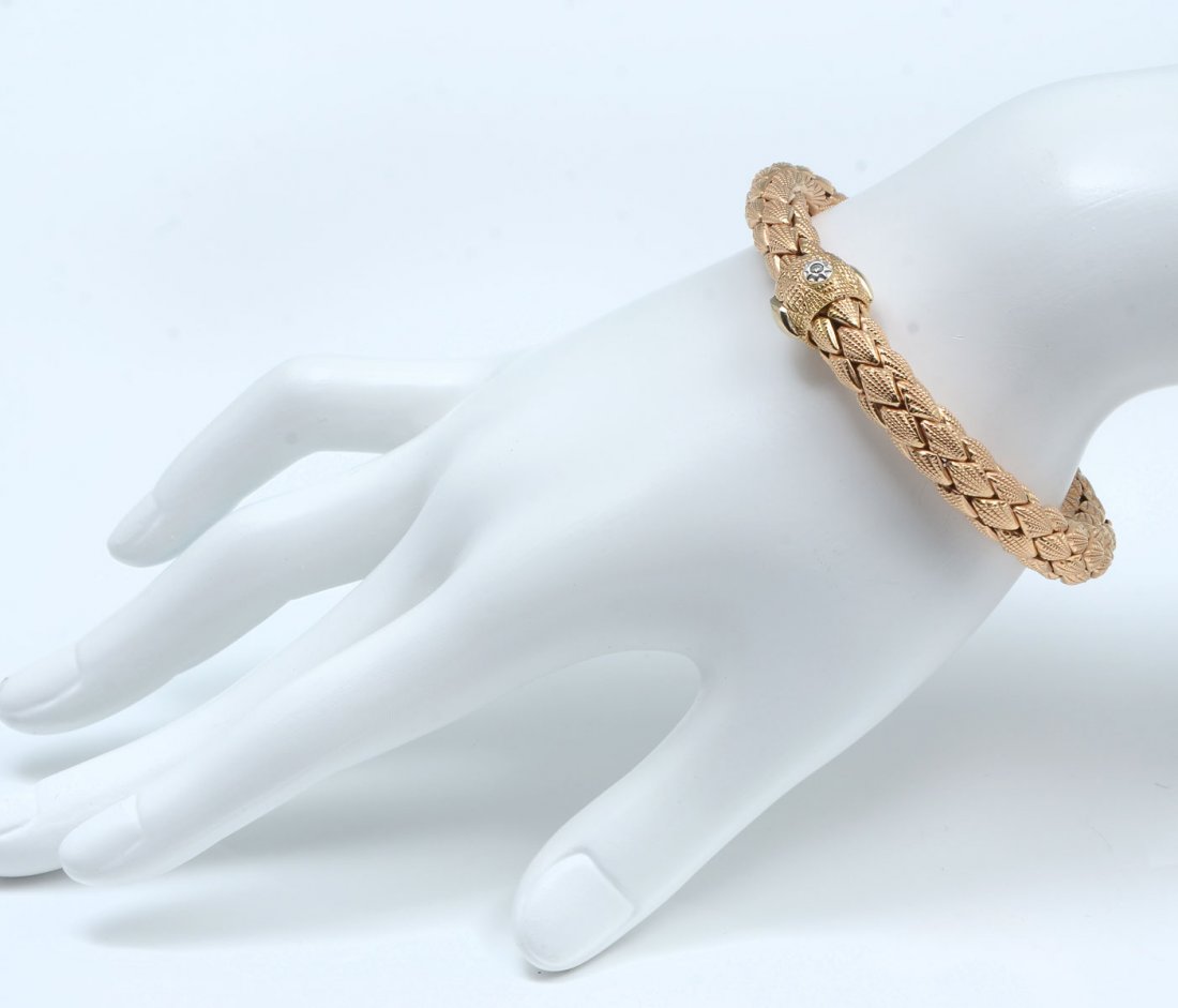 CHIMENTO 18K OFIDIO STRETCH LADIES BRACELET: CHIMENTO 18K OFIDIO STRETCH LADIES BRACELET: Uniquely designed Bracelet/Soft Bangle gold in a strand by Chimento Italian, a small diamond on the connection part. Bracelet length is measured as 8". Wei