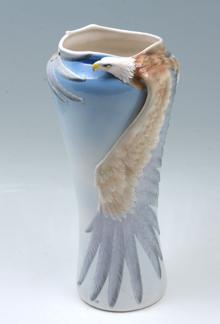 FRANZ POTTERY EAGLE VASE: FRANZ POTTERY EAGLE VASE: Large Franz pottery vase, having a clouded sky motif with a raised soaring Bald Eagle formed rim. Approx. 17'' h x 7.75'' w.