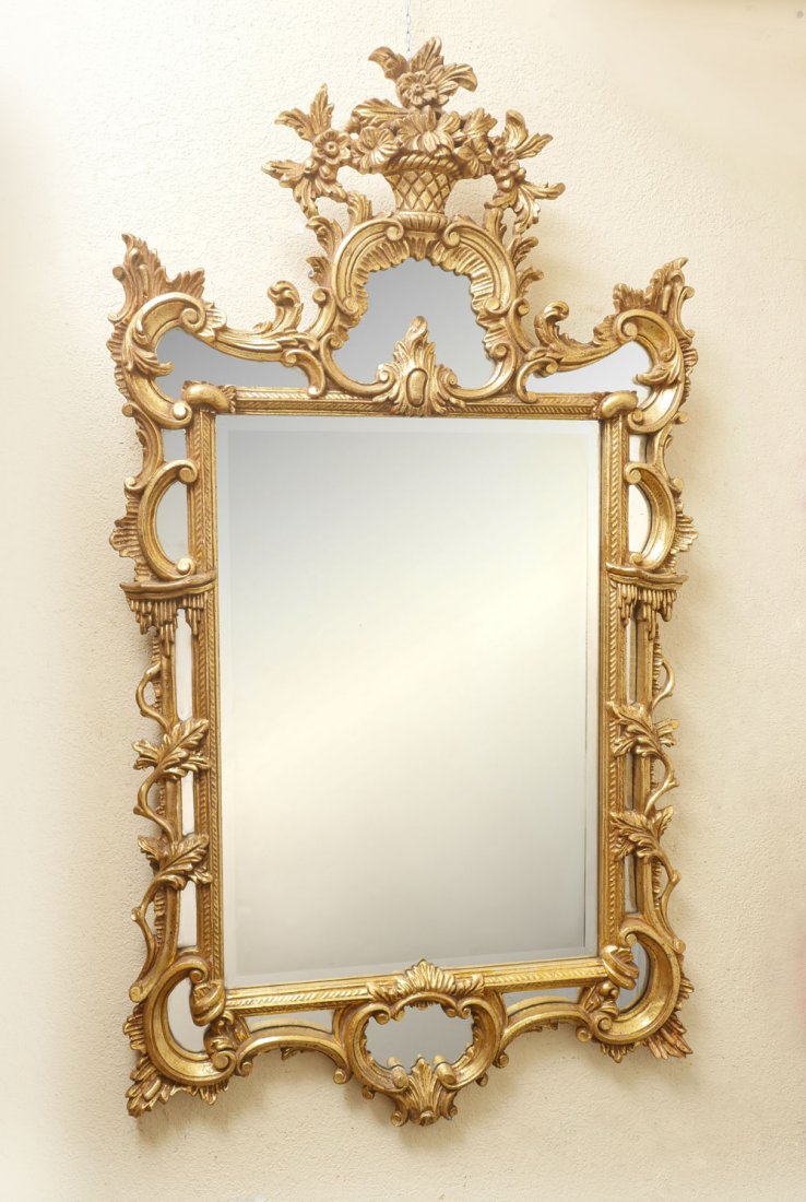 LARGE ORNATE GILT LA BARGE MIRROR: LARGE ORNATE GILT LA BARGE MIRROR: Large Italian gilt La Barge mirror, having an overall scrolling foliate design, surmounted by a floral basket. Approx. 58.5'' h x 32.5'' w.