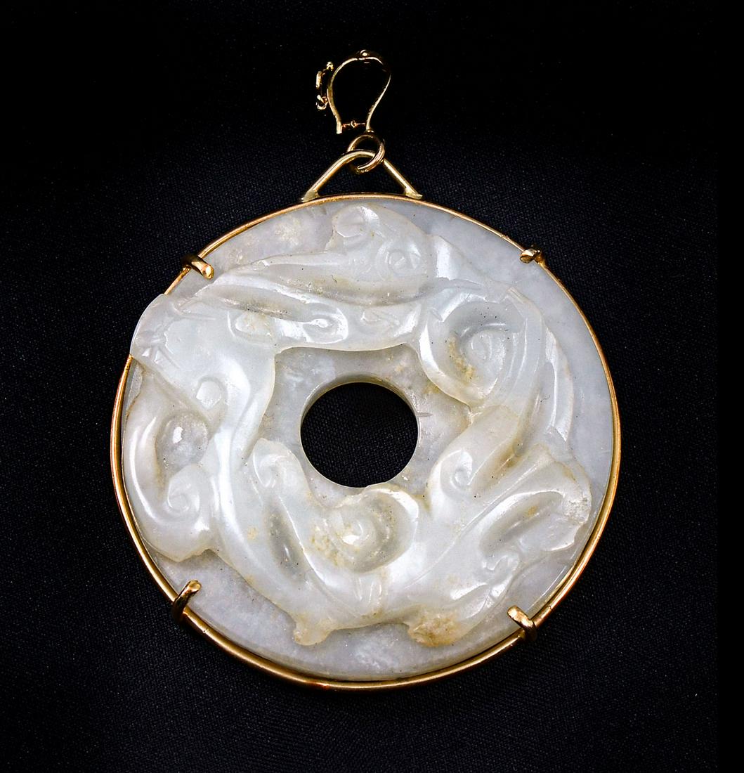MUTTON FAT JADE HYDRA MOTIF PENDANT IN 14K: MUTTON FAT JADE HYDRA MOTIF PENDANT IN 14K: Certified 19th Chinese Mutton Fat Jade, measures 55mm. Pi style with hydra motif in 14K frame and bale. Provenance: Fred S. and Rosemary Johnston Estate.