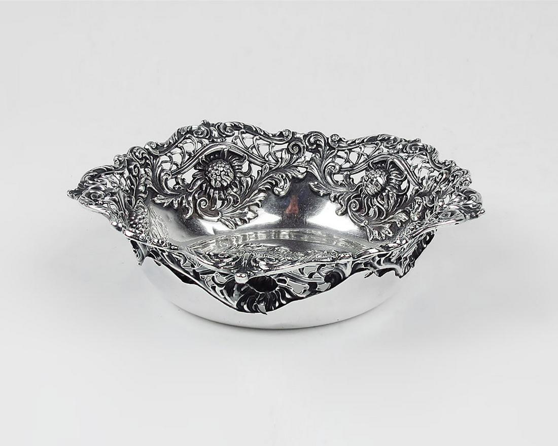 FRANK HERSCHEDE FLORAL REPOUSSE STERLING BOWL: FRANK HERSCHEDE FLORAL REPOUSSE STERLING BOWL: Approx. 4.6 Troy ounces Sterling. Repousse and pierced rim with a Sunflower and foliate scroll motif. By Redlich & Co., retailed by Frank Herschede, mark