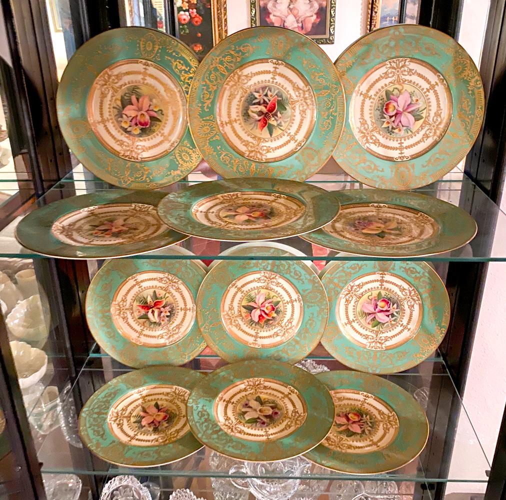12 ROYAL WORCESTER GILT ORCHID PLATES: 12 ROYAL WORCESTER GILT ORCHID PLATES: 12- English Royal Worcester dinner plates, having hand-painted Orchids in center. with an encompassing Gilt Sunflower medallion & scrolling foliate design on a g