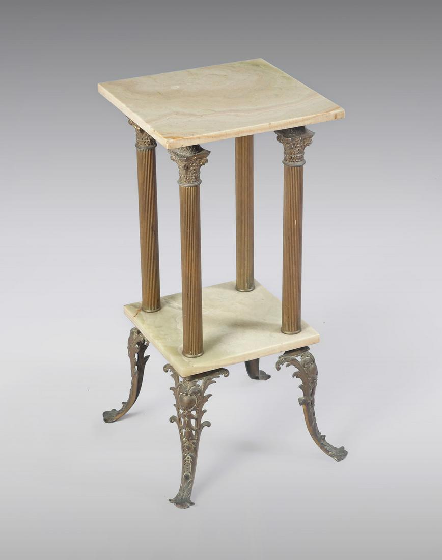 MARBLE AND BRASS LAMP TABLE: MARBLE AND BRASS LAMP TABLE: 2-Tier marble shelf stand, having brass ribbed columns. Raised on bronze foliate feet. Approx. 30.25'' h x 16'' l x 16'' w.