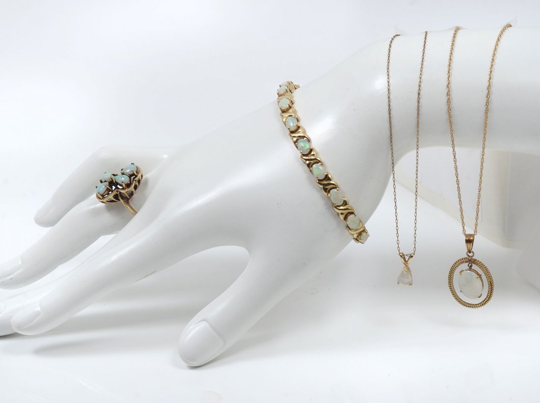14K 4 PIECE OPAL JEWELRY LOT: 14K 4 PIECE OPAL JEWELRY LOT: A combination of 10K & 14K yellow gold jewelry set with opals. 1) 10K ring set with 4 opals, size 5. Weight 4.2 grams; 2) 14K 17 opals set in this X-O style bracelet, 7" 