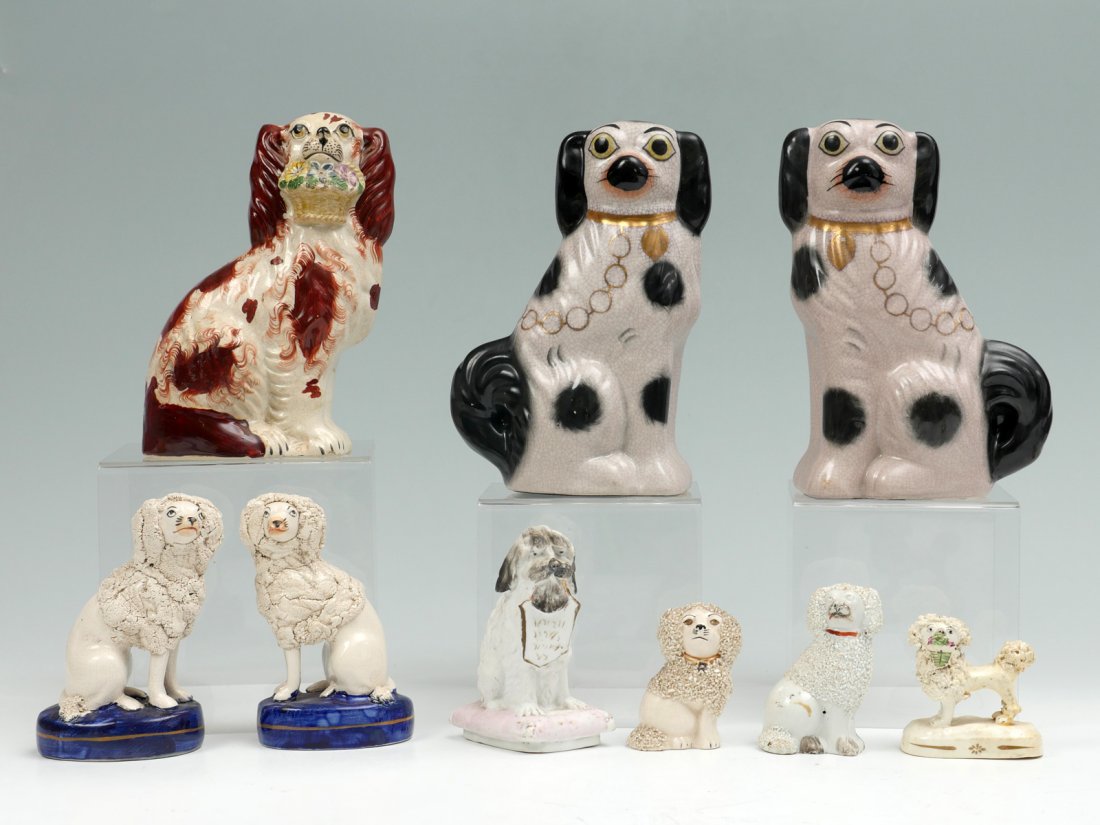 8 PC. STAFFORDSHIRE PORCELAIN DOG STATUES: 8 PC. STAFFORDSHIRE PORCELAIN DOG STATUES: Comprising; 2- Opposing Cocker Spaniels. 1- Cocker Spaniel with a floral basket in mouth. 2- Opossing Poodles on blue bases. 2- Poodles. 1- Poodle with a flo