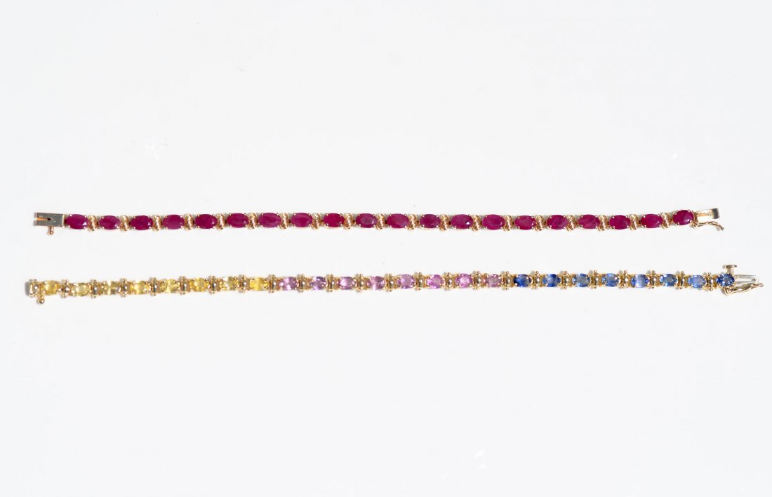 2 14K GEMSTONE BRACELETS: 2 14K GEMSTONE BRACELETS: 1) 14K yellow gold bracelet set with 20 rubies. 7" long and weight 8 grams; 2) 14K yellow gold multi-gemstone bracelet, 7.5" long.Weight 11.3 grams. Marked 14K