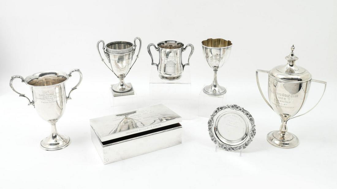 7 STERLING PRESENTATION TROPHIES & COMMEMORATIVE: 7 STERLING PRESENTATION TROPHIES & COMMEMORATIVE AWARDS: Approx. 57.49 Troy ounces (not including weight of presentation box). Comprising; 1- Trophy cup for Clay Pigeon shooting, 1- Trophy plate for P