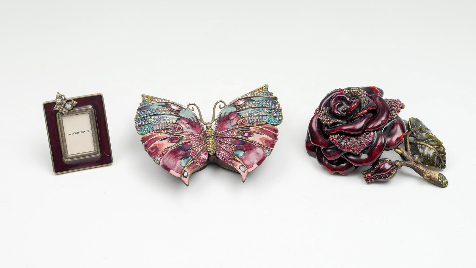 3 PC JAY STRONGWATER ITEMS IN ORIGINAL BOXES: 3 PC JAY STRONGWATER ITEMS IN ORIGINAL BOXES: 1) Mini rectangular red enamel frame with butterfly accent; butterfly set with 2 Swarovski crystals. Measures 1.75'' x 2.25''. Marked Jay Strongwater and 