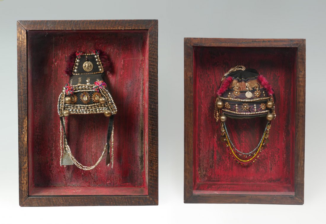 2 PIECE TIBETAN HEADDRESSES IN SHADOW BOXES: 2 PIECE TIBETAN HEADDRESSES IN SHADOW BOXES: 2- Tibetan ceremonial headdresses in presentation boxes with glass front hinged doors. Red painted interiors. Headdresses adorned by yarn, beads, shells, &
