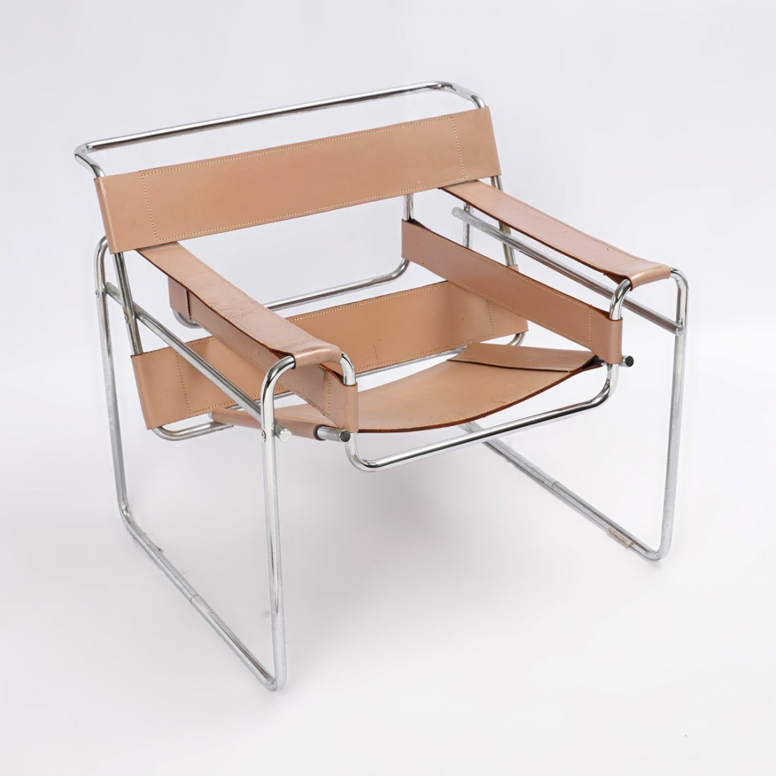 CONTEMPORARY MARCEL BREUER WASSILY STYLE CHAIR: CONTEMPORARY MARCEL BREUER WASSILY STYLE CHAIR: Mid-century modern Wassily style chair, in the style of Marcel Breuer for Knoll. Tan leather straps on chromed frame. Approx. 27.5" h x 30.5" l x 30" w.