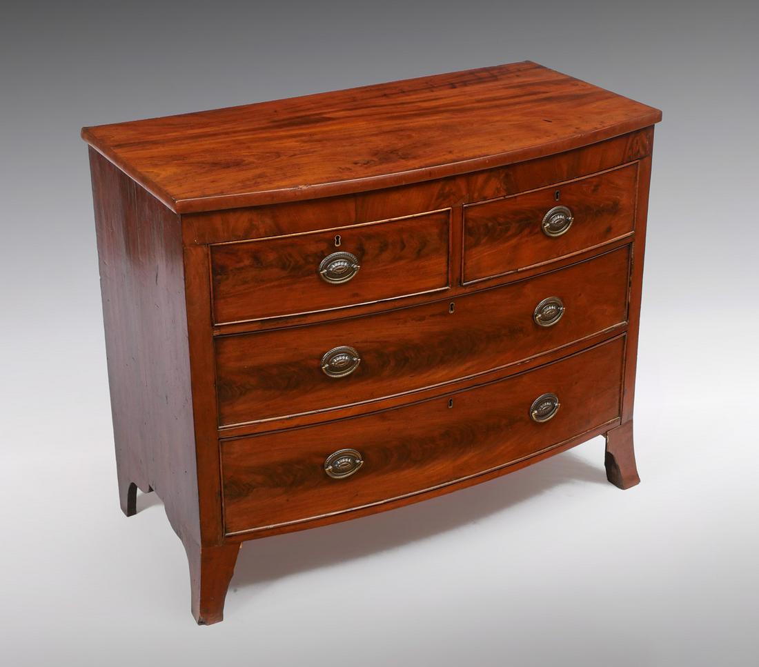 BOWFRONT CHEST: BOWFRONT CHEST: Early 19th C. 2 drawer over 2-drawer bowfront chest with floral medallion brass bail handles. Raised on sprawling feet. Approx. 34.5" h x 42" l x 21" w.