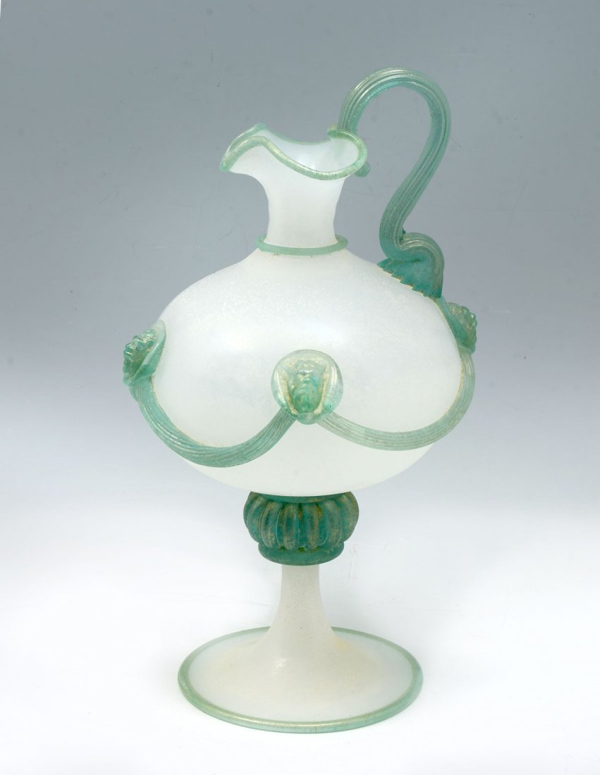 MARIO GAMBARO MURANO VASE: MARIO GAMBARO MURANO VASE: Large Italian Murano Ewer form vase, by Mario Gambaro, having Gold flecked Bacchus medallions with draping between, with a Scavo finish. Signed at underside. Approx. 16.5" h