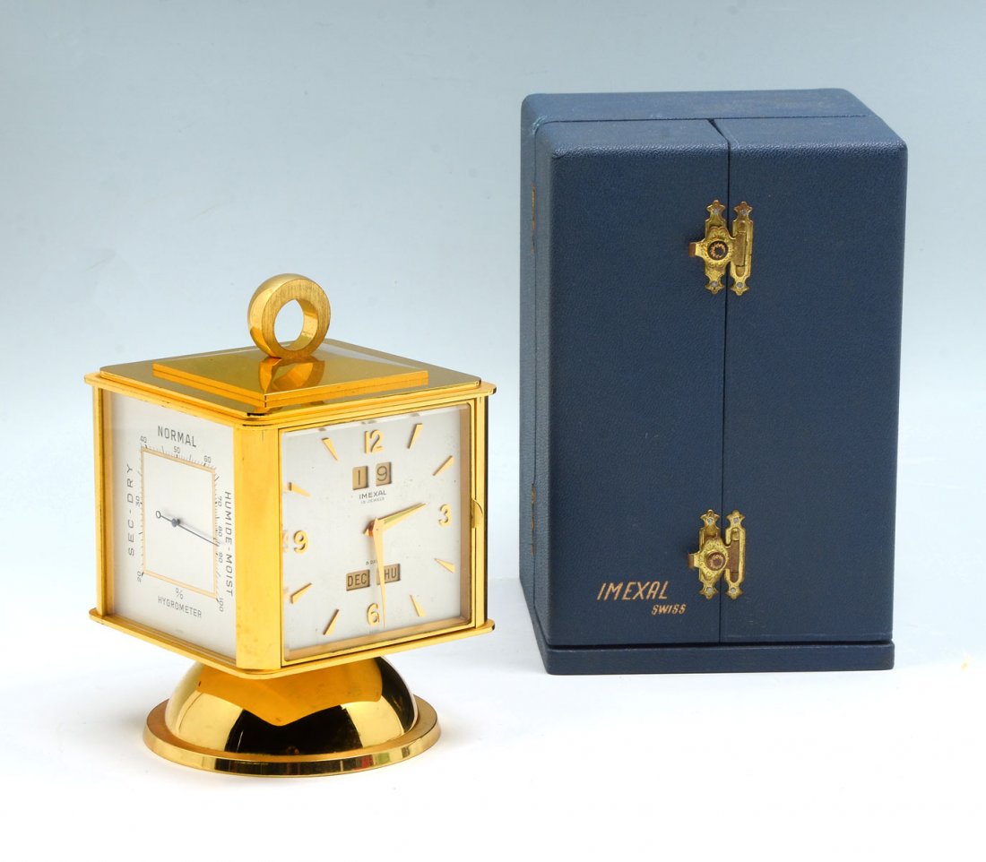 IMEXAL SWISS CLOCK IN ORIGINAL BOX: IMEXAL SWISS CLOCK IN ORIGINAL BOX: 8- Day Swiss Imexal desk clock in original case. 15- Jewels. Clock also has a Barometer, Hygrometer, & Thermometer at each face. Original paperwork also included. A