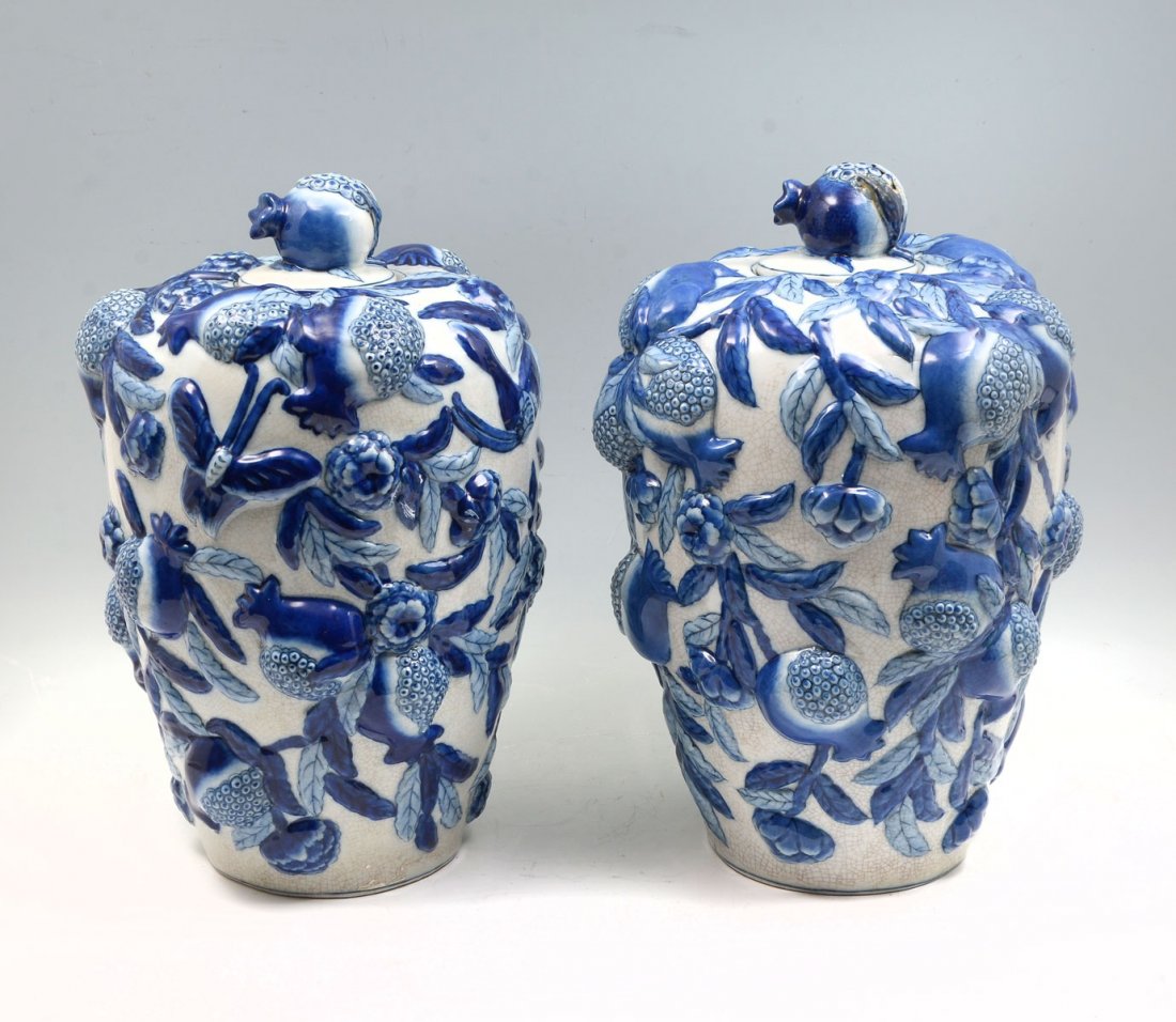 PAIR OF CONTEMPORARY CHINESE DRAGONFLY VASES: PAIR OF CONTEMPORARY CHINESE DRAGONFLY VASES: Pair of Chinese, Wong Lee, Blue & White lidded vases, having a raised Peach & Butterfly encompassing design. Underside of each marked with a "WL 1895". Ap