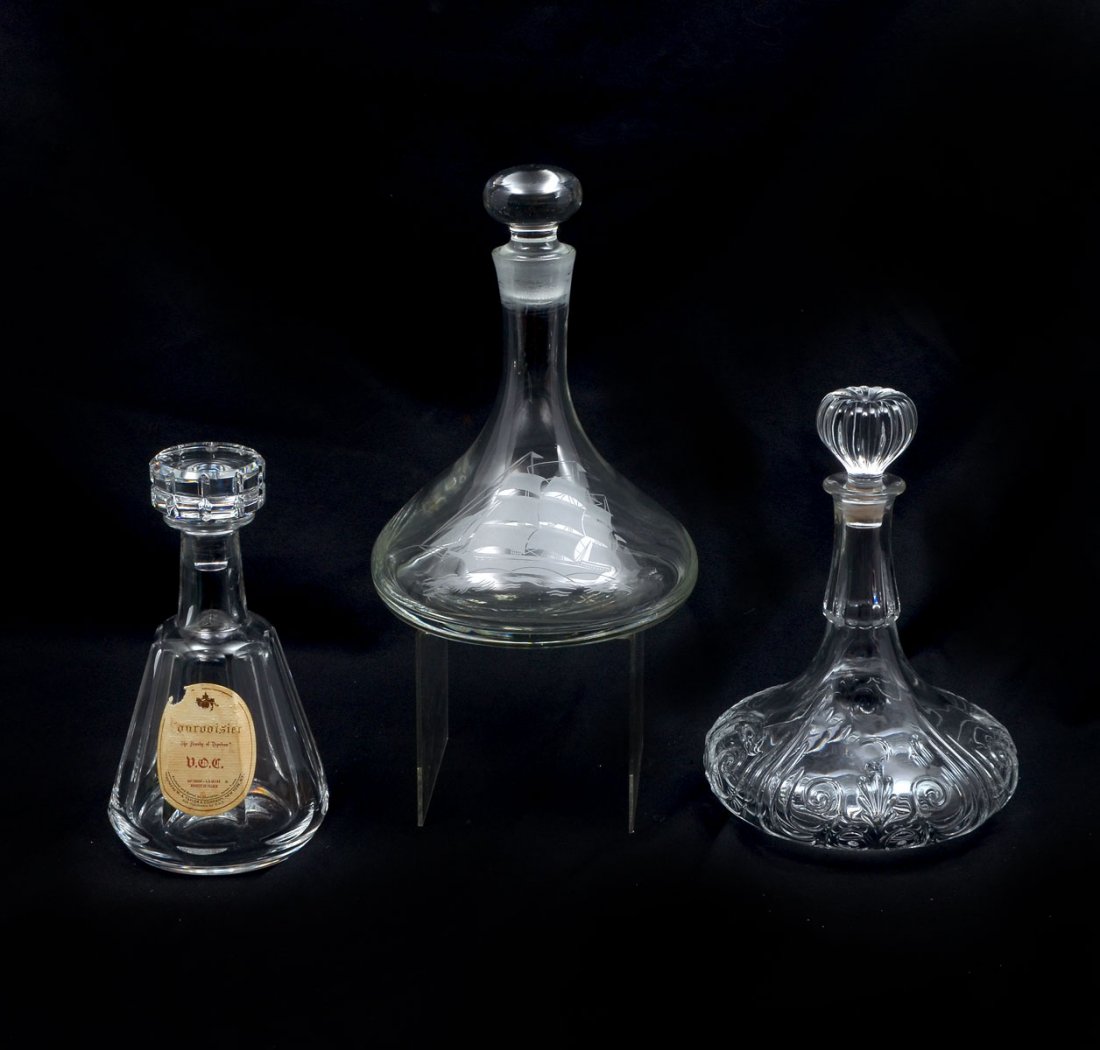 3 PC. DECANTER COLLECTION TO INCLUDE BACCARAT: 3 PC. DECANTER COLLECTION TO INCLUDE BACCARAT: Comprising; 1- Baccarat decanter for Courvoisier, Baccarat decanter for G. Austin Nicholas & Co. of New York, & 1- Blown glass ship's decanter, having an