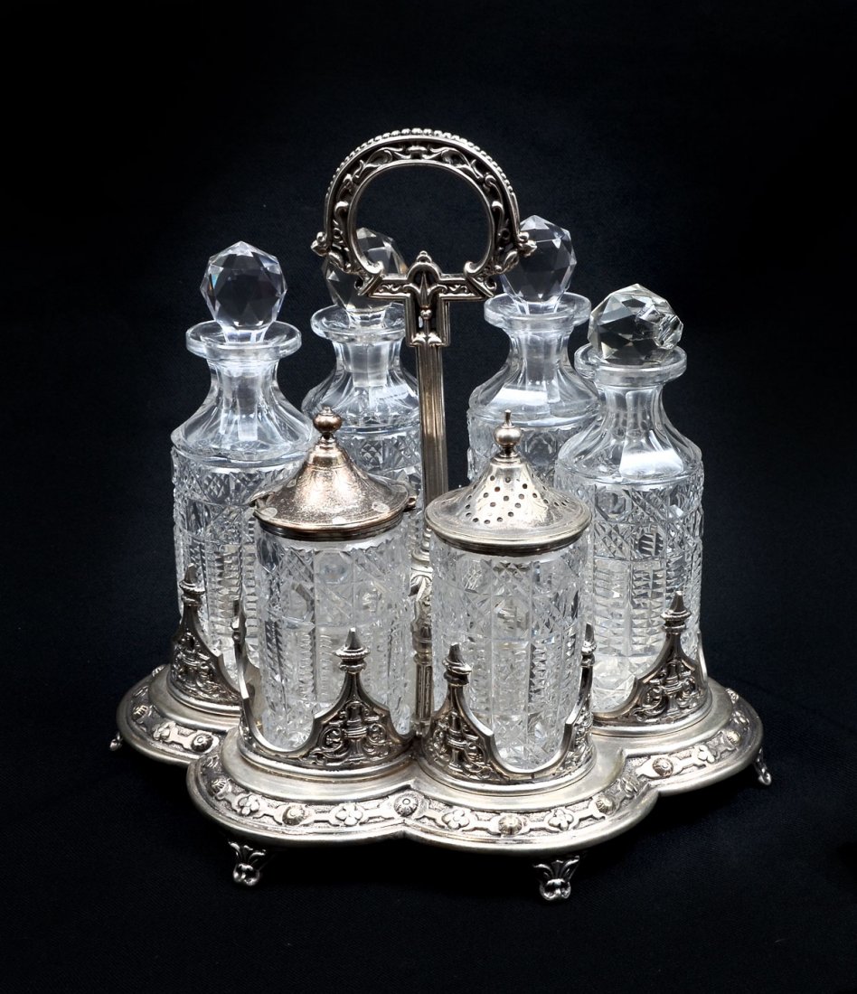 A GEORGE III ENGLISH SILVER PLATE CONDIMENT TRAY: A GEORGE III ENGLISH SILVER PLATE CONDIMENT TRAY: Comprising; 4- Cut glass bottles with stoppers, 1- Lidded powder shaker, 1- Lidded sugar. All reside in a silver plated handled tray. Made by Nathanie