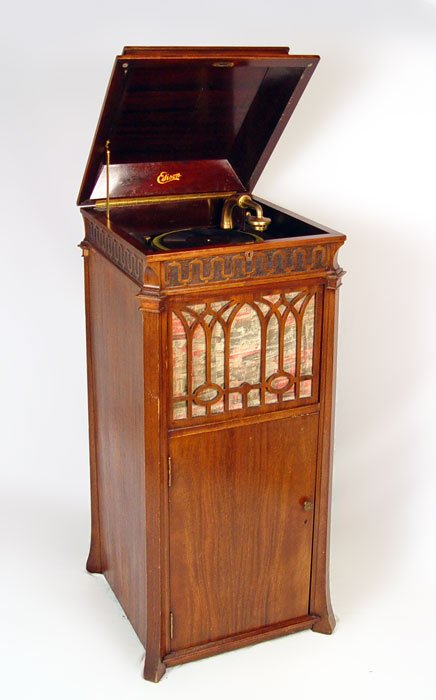 EDISON C250 CHIPPENDALE CABINET PHONOGRAPH: EDISON C-250 CHIPPENDALE UPRIGHT CABINET PHONOGRAPH: Circa 1915-1919, serial number SM 28898. Cranks and platter spins. Includes 5 records & spare parts, please note chips to veneer. Measures 49 1/2"