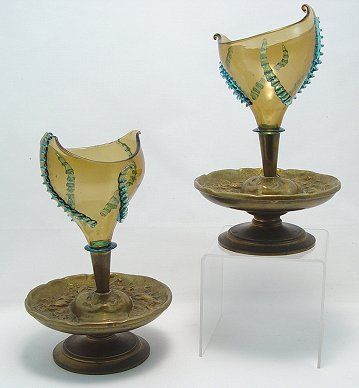 PAIR OF BRONZE AND ART GLASS EPERGNES MUST SEE: PAIR OF BRONZE AND ART GLASS EPERGNES: Bronze faces appear to be blowing the glass trumpet shaped vases. The vases are early blown glass with aqua colored rigaree. Please note loss of one of the curls