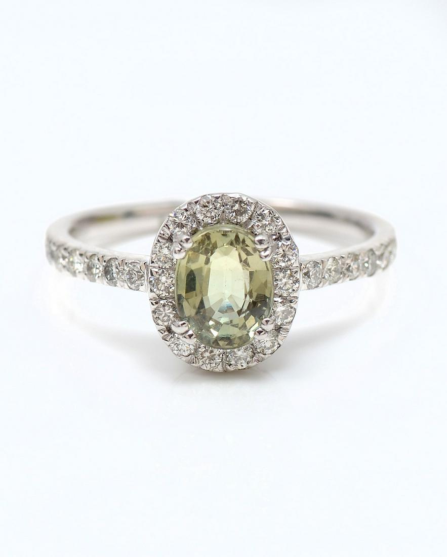 PLATINUM ALEXANDRITE & DIAMOND RING BY ORIANNE: PLATINUM ALEXANDRITE & DIAMOND RING BY ORIANNE: 1.17 Ct oval mixed cut Alexandrite is set within a diamond bezel in this platinum setting. Alexandrite has an appealing change of color. 26 diamonds app