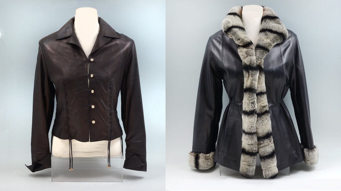 2 LADIES LEATHER FASHION JACKETS: 2 LADIES LEATHER FASHION JACKETS: 1) Beautiful 3/4 length black leather jacket with striped fur collar, cuffs and front trim. Draw strong at waist with hook and eye closures. 2 front pockets and 1 ins
