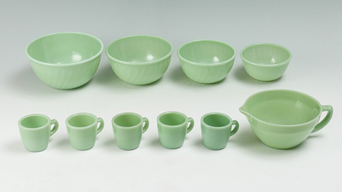10 PC. FIRE KING JADEITE OVEN WARE COLLECTION: 10 PC. FIRE KING JADEITE OVEN WARE COLLECTION: Comprising; 1- handled mixing bowl, 5- handled coffee mugs/cups, & 4- graduated nesting mixing bowls, of the swirl design. Undersides of all have raised