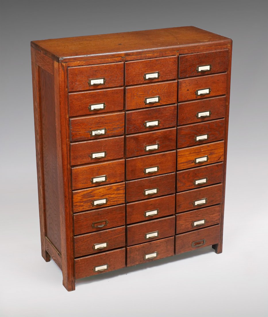 VINTAGE OAK FILE CABINET: VINTAGE OAK FILE CABINET: 27- Drawer oak filing cabinet with metal framed drawers, some being compartmented. Metal pulls. Approx. 43.75" h x 33.5" l x 16" w.