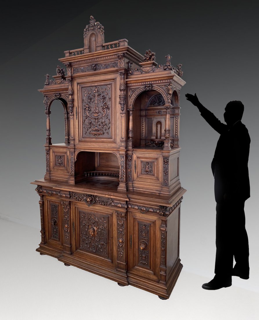LARGE CARVED WALNUT STEP BACK CUPBOARD: LARGE CARVED WALNUT STEP BACK CUPBOARD: Elaborately carved 6- door, 3- drawer, stepback cupboard with turned & carved columns at archways. Carved scrolling foliate designs, Masques, & Lions. Approx. 1