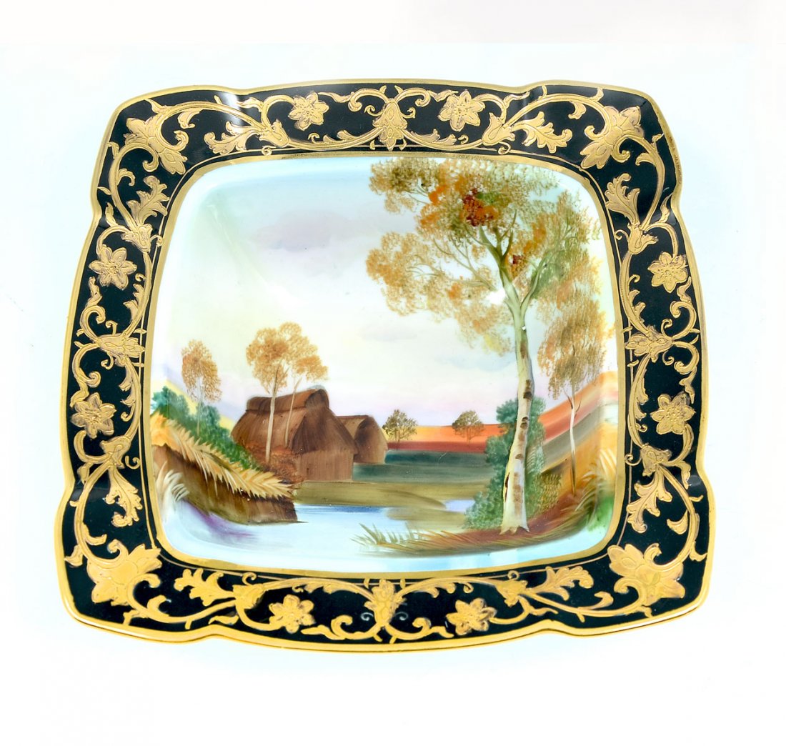 HAND PAINTED NIPPON SCENIC BOWL: HAND PAINTED NIPPON SCENIC BOWL: Square Nippon hand-painted bowl with flared rim. Waterside village scene in center with an encompassing black rim. Rim has a Gold painted scrolling foliate design. App
