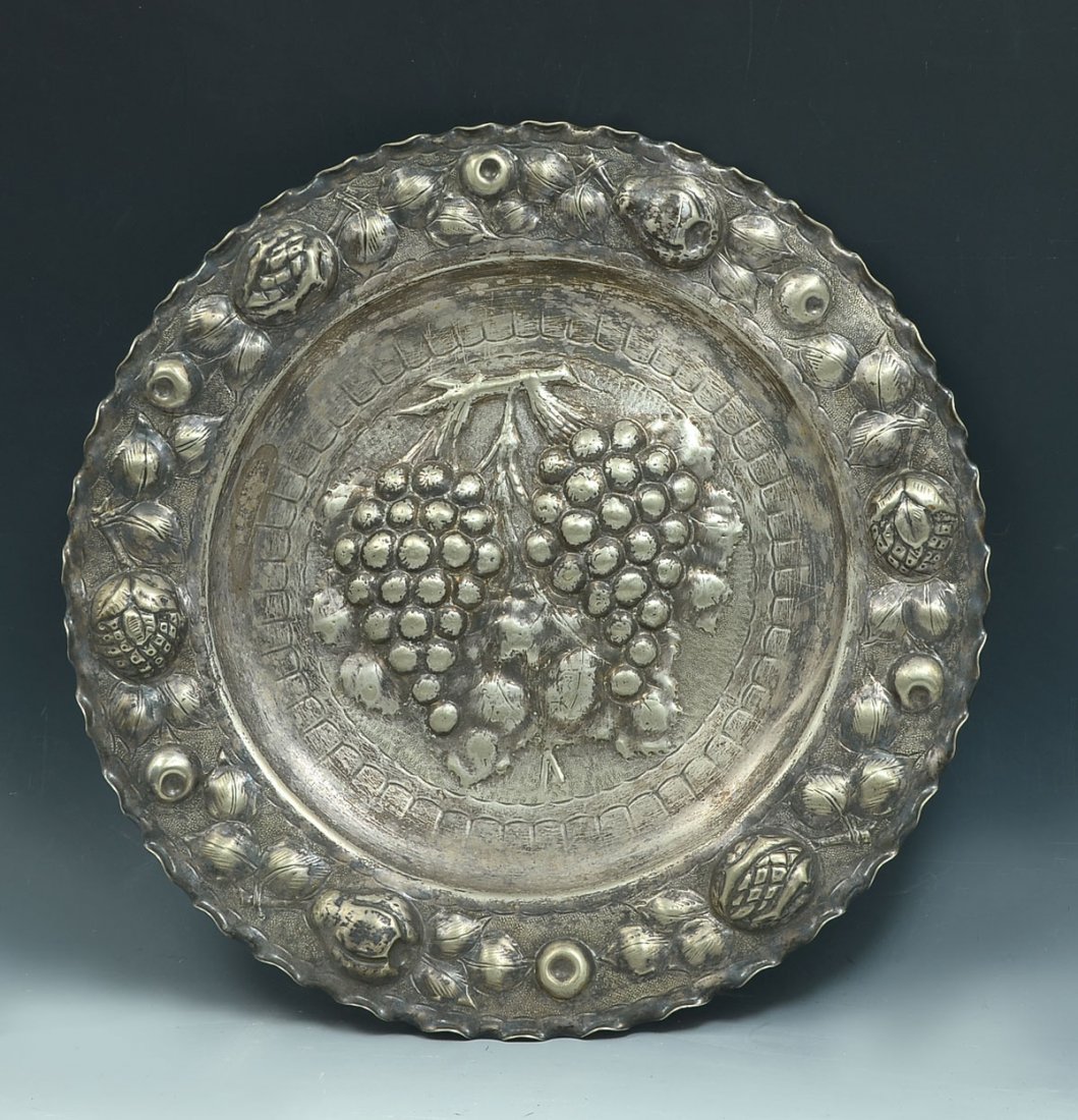 ELABORATELY SILVER PLATED PERUVIAN CHARGER: ELABORATELY SILVER PLATED PERUVIAN CHARGER: Large Peruvian silver plated charger having a central raised Grapevine cluster with an encompassing fruit & foliate design. Verso has an impressed, C.D.B., 