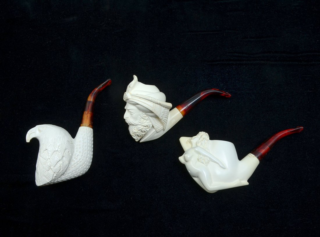 3 PC. CARVED MEERSCHAUM PIPE COLLECTION: 3 PC. CARVED MEERSCHAUM PIPE COLLECTION: Comprising; 1- Erotic nude female pipe, 1- Middle Eastern male figure with Turban, & 1- Bald Eagle. All reside in their original cases. Largest Approx. 3.25" h