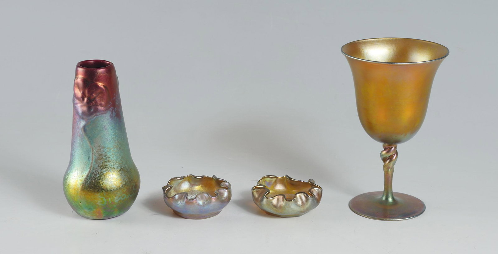 4 PC. WELLER SICCARD, TIFFANY & STEUBEN ART GLASS: 4 PC. WELLER SICCARD, TIFFANY & STEUBEN ART GLASS COLLECTION: Comprising; 1- Steuben Aurene #2361, art glass chalice with a twisted stem. 2- Tiffany Favrile art glass finger bowls, signed L.C.T. & unk