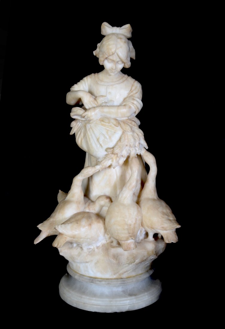 EXCEPTIONAL MARBLE SCULPTURE BY E. BATTIGLIA: EXCEPTIONAL MARBLE SCULPTURE BY E. BATTIGLIA: Goose Girl, 23.5" in height, signed verso, depicts a young girl feeding a group of geese, sits atop a beveled pedestal which adds another 4.5".