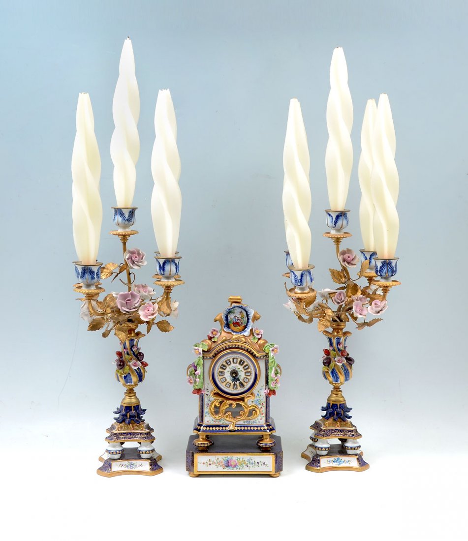 3 PC. FRENCH GARNITURE SET: 3 PC. VINTAGE SEVRES FRENCH GARNITURE SET: Comprising; 1- Mantle clock with attached draped floral & foliate. Surmounted by a hand-painted figural medallion. 2- Five light candelabra, of a tree form, 