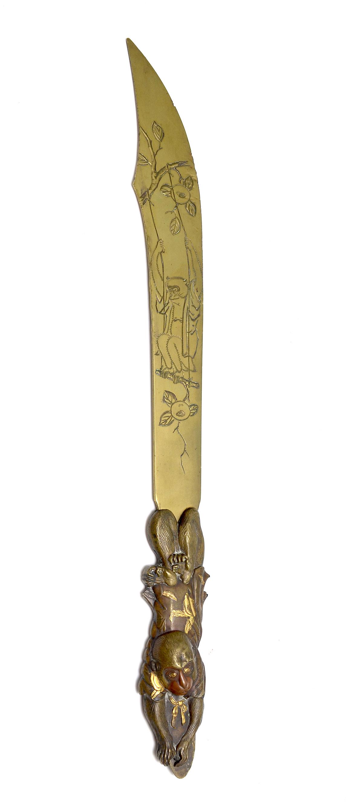 JAPANESE MONKEY FORM PAGE TURNER/PAPER KNIFE: JAPANESE MONKEY FORM PAGE TURNER/PAPER KNIFE: Japanese Meiji period paper knife, having an incised brass blade with a swinging monkey & birds amongst a fruit tree. Copper monkey form handle with Gold 