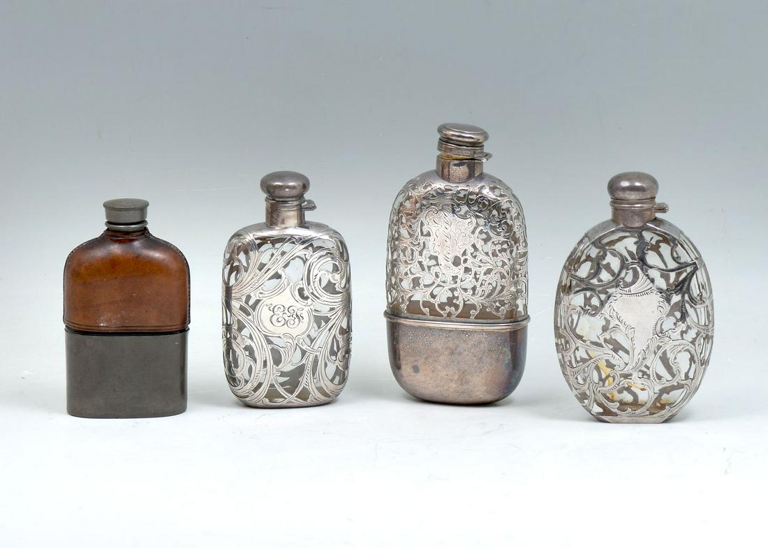 4 PC. FLASK COLLECTION TO INCLUDE STERLING OVERLAY: 4 PC. FLASK COLLECTION TO INCLUDE STERLING OVERLAY: Comprising; 1- Gorham decanter with an upper scrolling foliate design and a solid overlayed base. Monogrammed Mrs. L.L.B. 1- Alvin pure silver overl