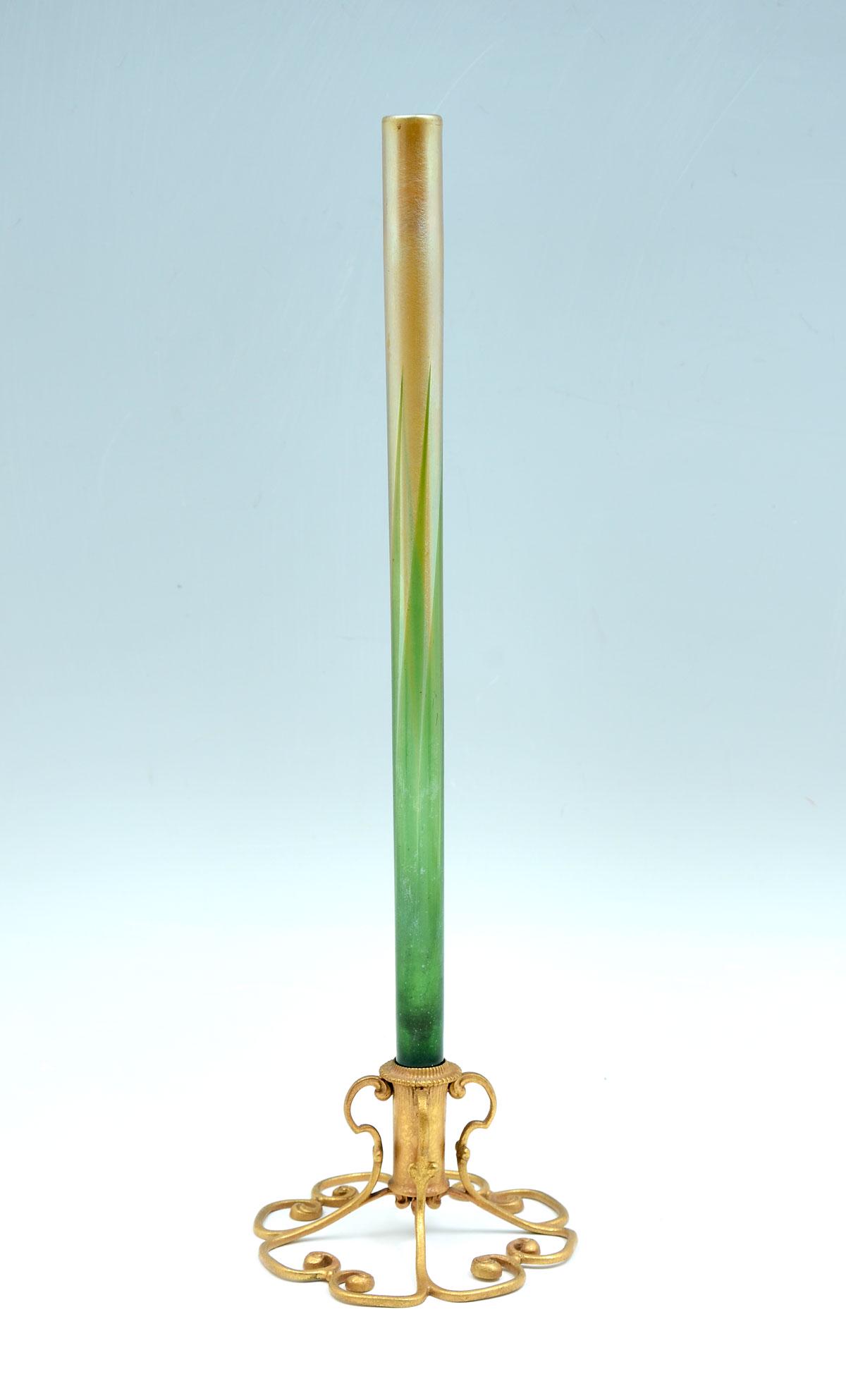 TALL TIFFANY ART GLASS BUD VASE: TALL TIFFANY ART GLASS BUD VASE: Gilt bronze floriform vase with a mottled finish. Impressed Tiffany Studios, New York, #714. Pulled feather gold to green iridescent. Glass could be signed, but we do 